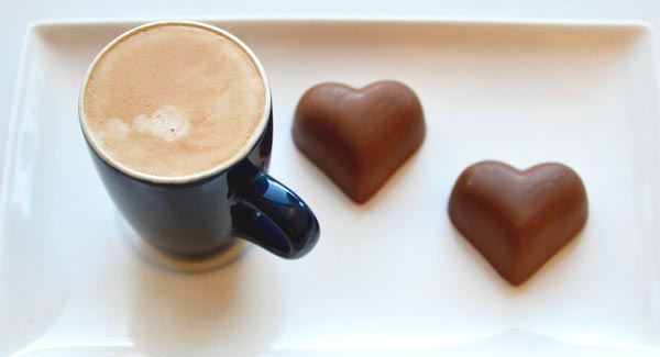 Cup of Coffee with Chocolate Hearts on a Plate.